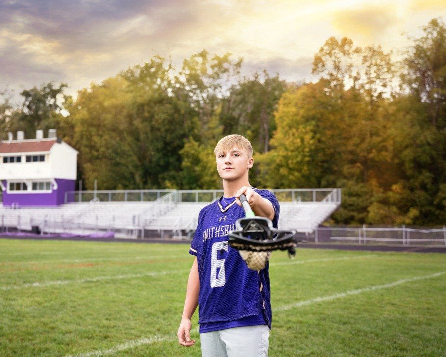 High school lacrosse senior portrait in uniform on the field in Shenandoah County, Virginia