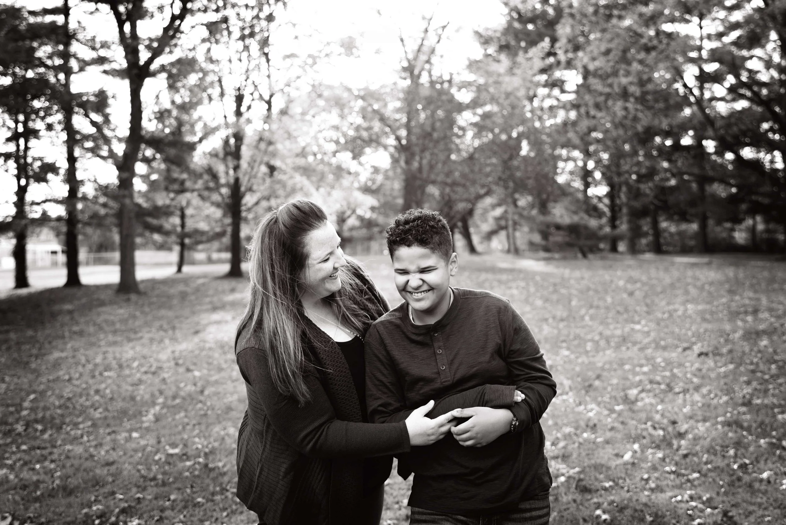 Black and white portrait of a mother and son laughing together during an outdoor family photography session in Woodstock, Virginia 