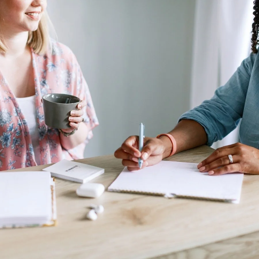 two women at a table planning a website project