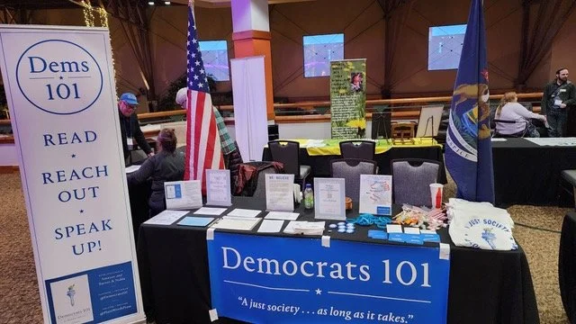 Dems101 table at MI Rural summit 2025.jpeg