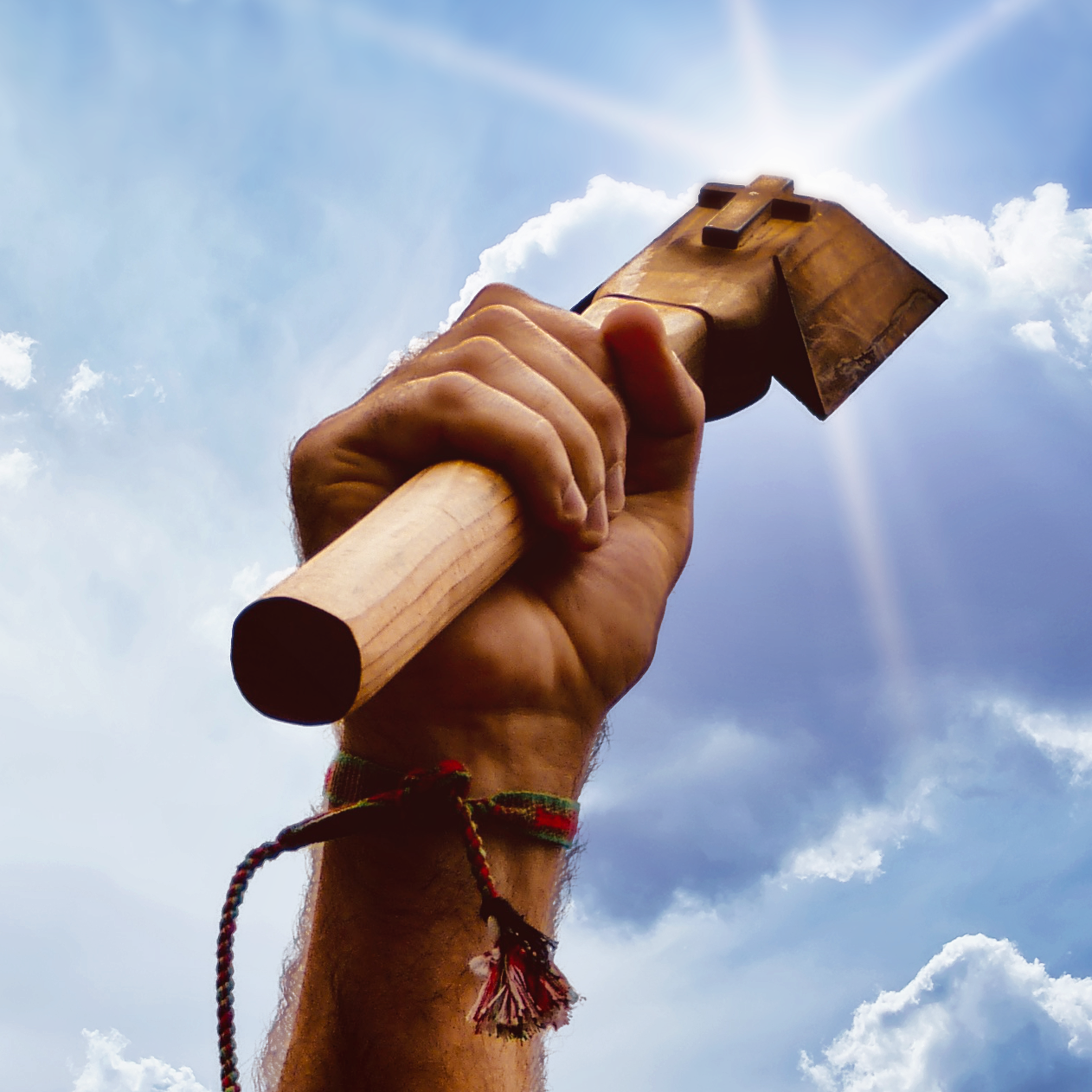 Spiritual healer holding sacred cross for a healing session.