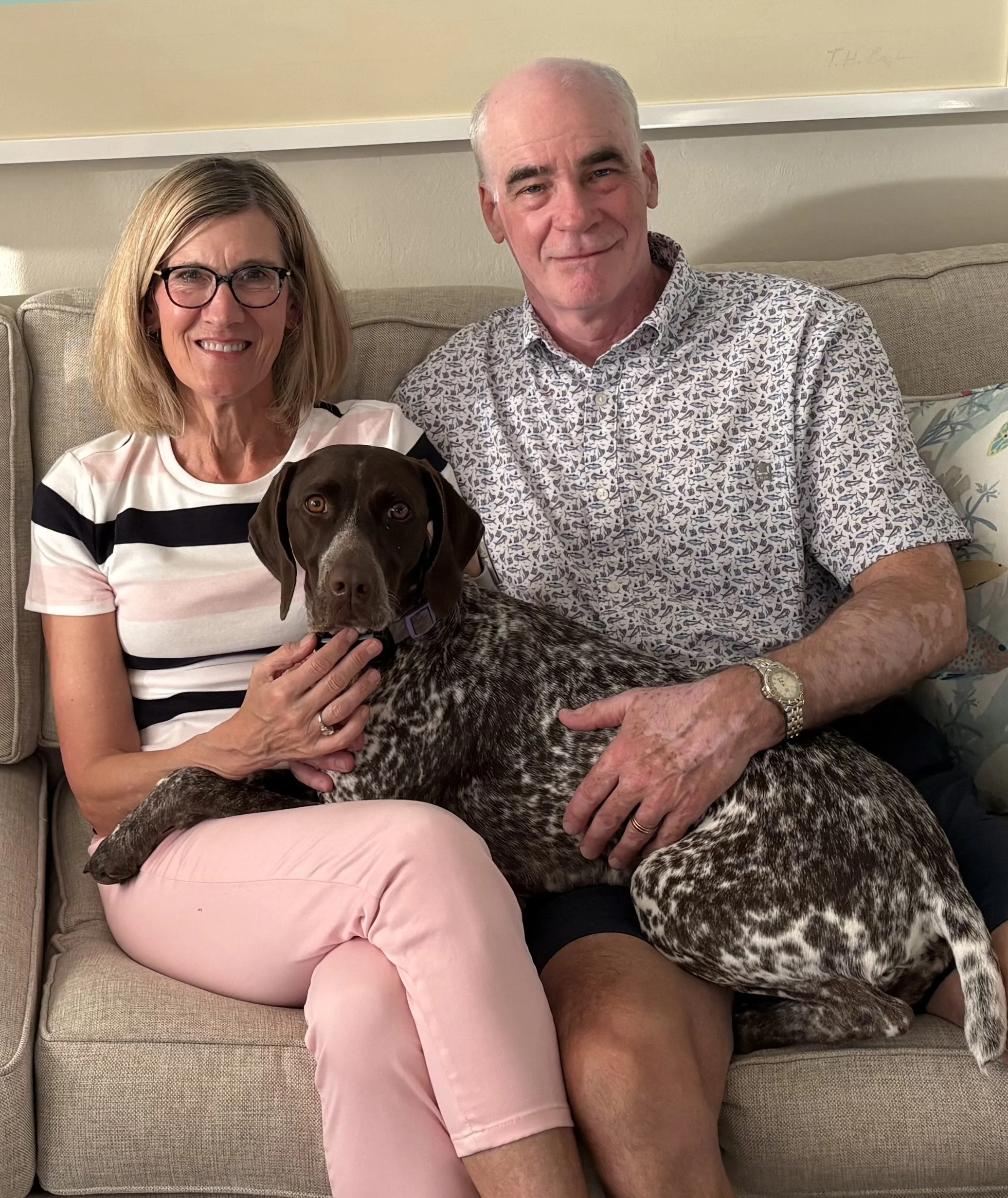 A couple with their German Shorthaired Pointer