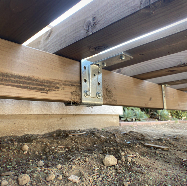 Wooden deck boards flexing beneath a walking foot