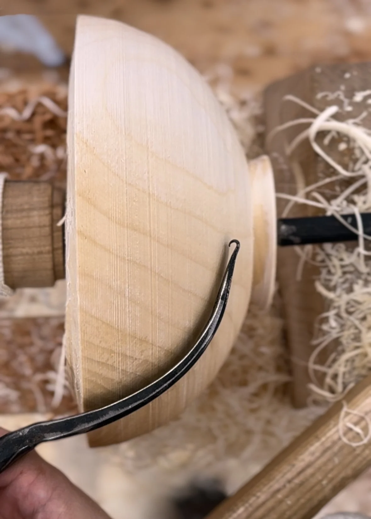 Sizing up a nesting hook for the bowl I was turning.