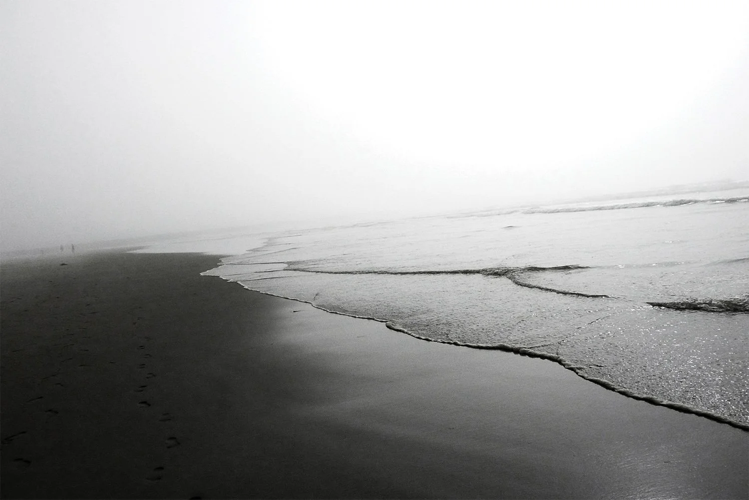 Foggy Oregon Coast day walking in the sand and ocean waves rolling in. 
