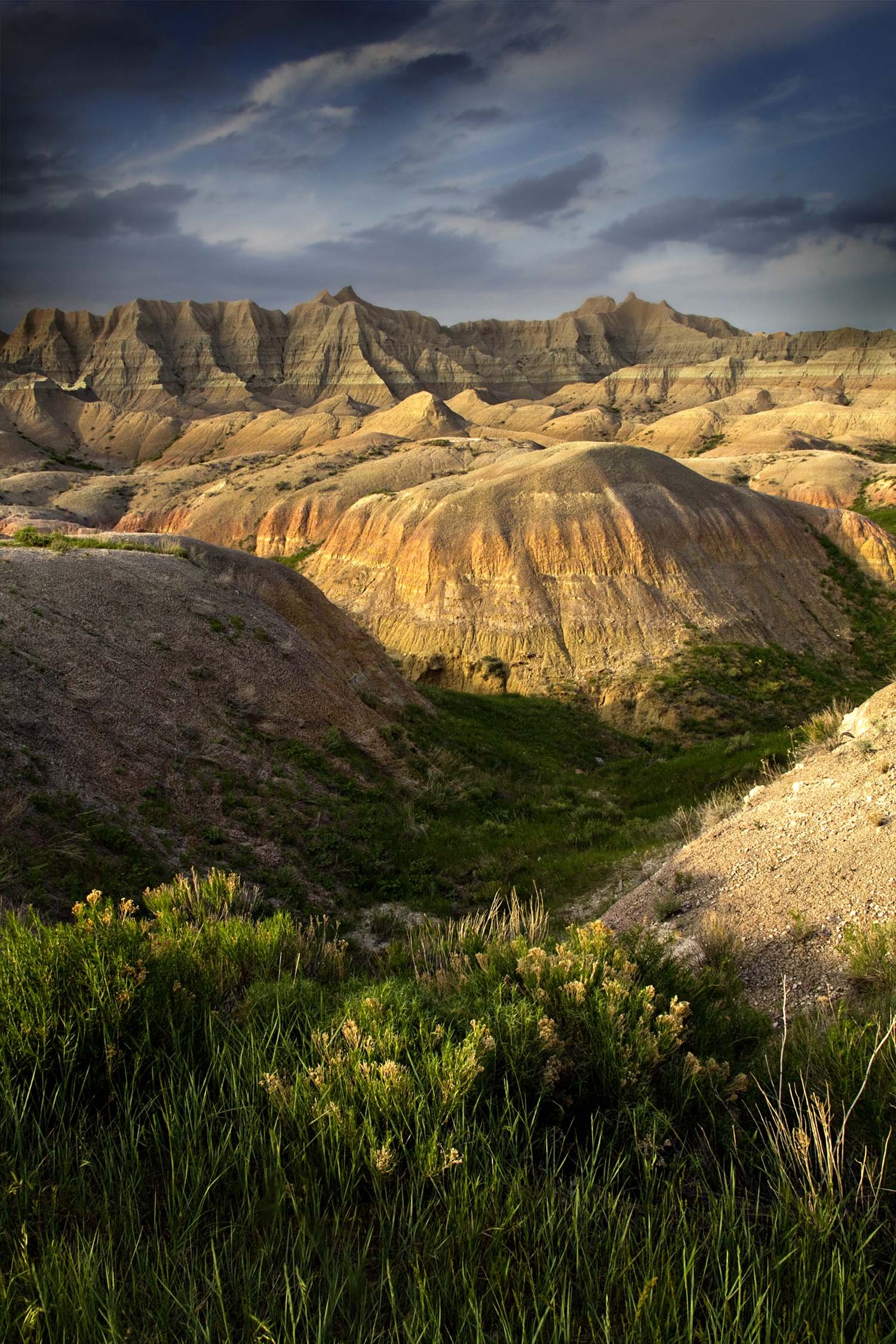 View of Badlands National Park South Dakota. Sun shining with a warm glow on the landscape.