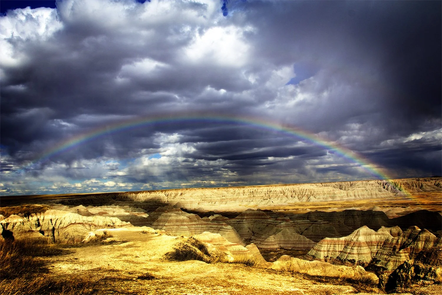 Rainbow and clouds over a canyon in Badlands National Park South Dakota.