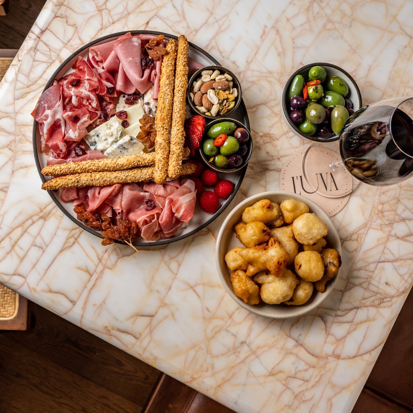Tagliere salumi &amp; cheese with a side of our pittole (puffed up small balls of dough, that are crispy on the outside and soft on the inside, ours are stuffed with anchovy, onion and tomato) 
Perfect way to start any meal. 

Check the link in our b