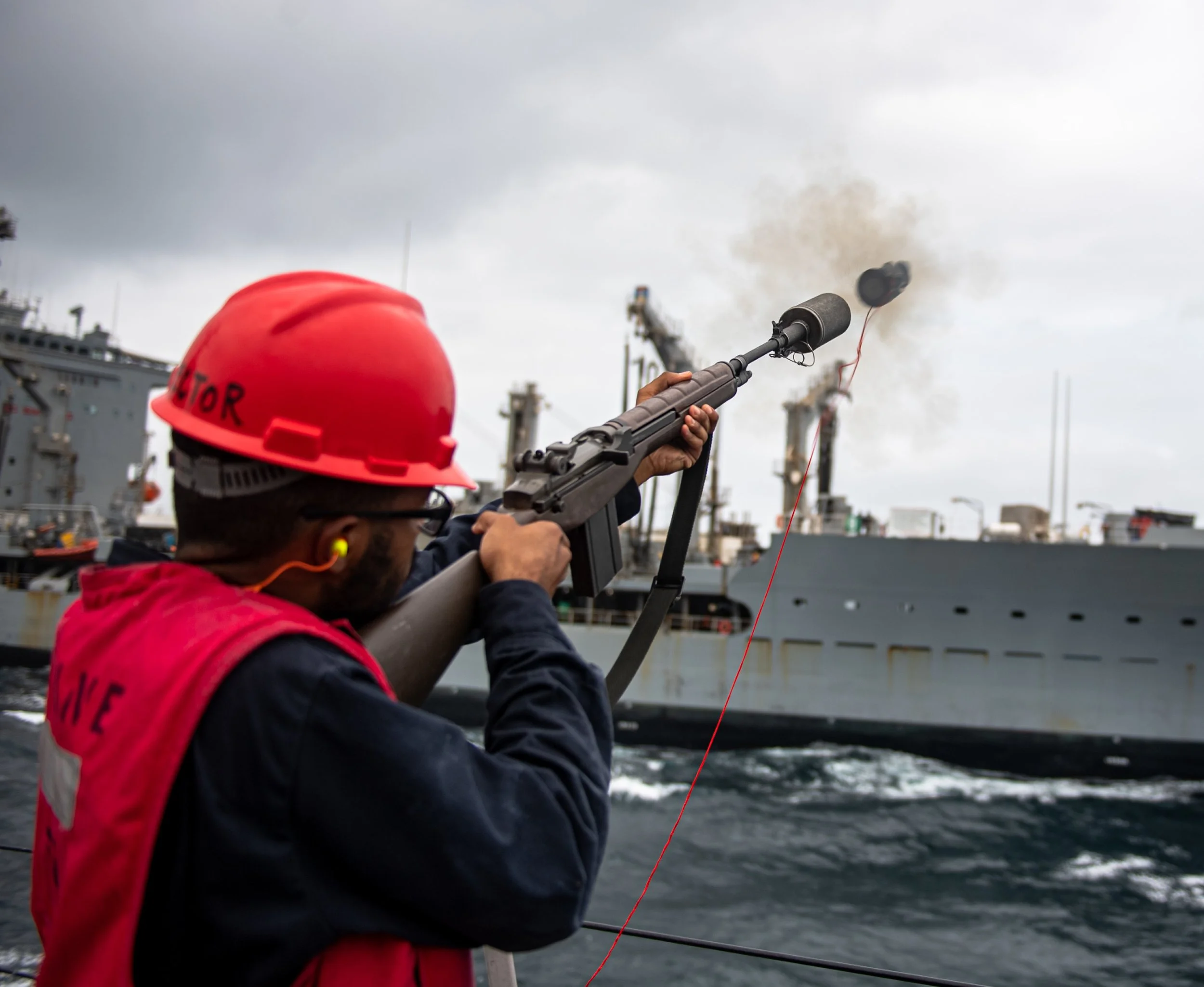  ARABIAN SEA (Sept. 5, 2021) Gunner’s Mate 3rd Class Jordan Floyd fires a shot line to underway replenishment oiler USNS Pecos (T-AO 197) during a replenishment-at-sea aboard guided-missile destroyer USS O’Kane (DDG 77) in the Arabian Sea, Sept. 5. (