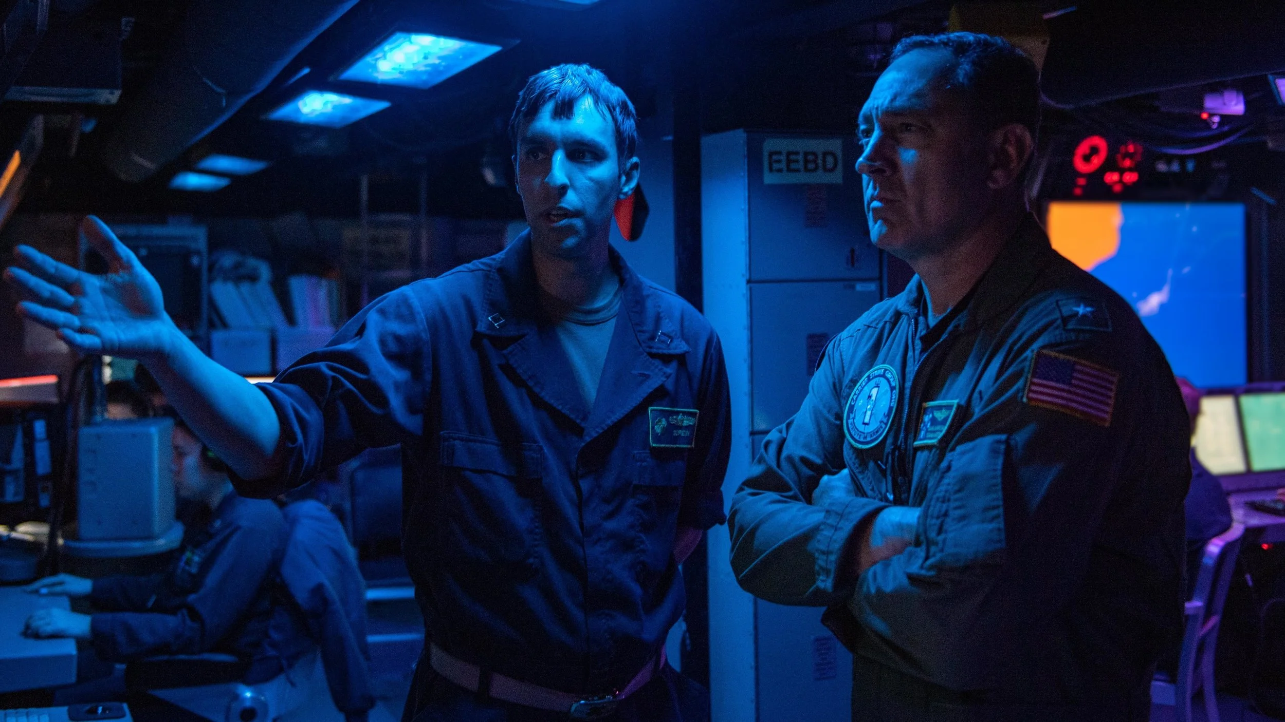  SOUTH CHINA SEA (Jan. 14, 2022) Rear Adm. Daniel Martin, right, commander, Carrier Strike Group (CSG) 1, speaks with Lt. Daniel Gerew, a native of Tom’s River, N.J., in the combat information center aboard Arleigh Burke-class guided-missile destroye