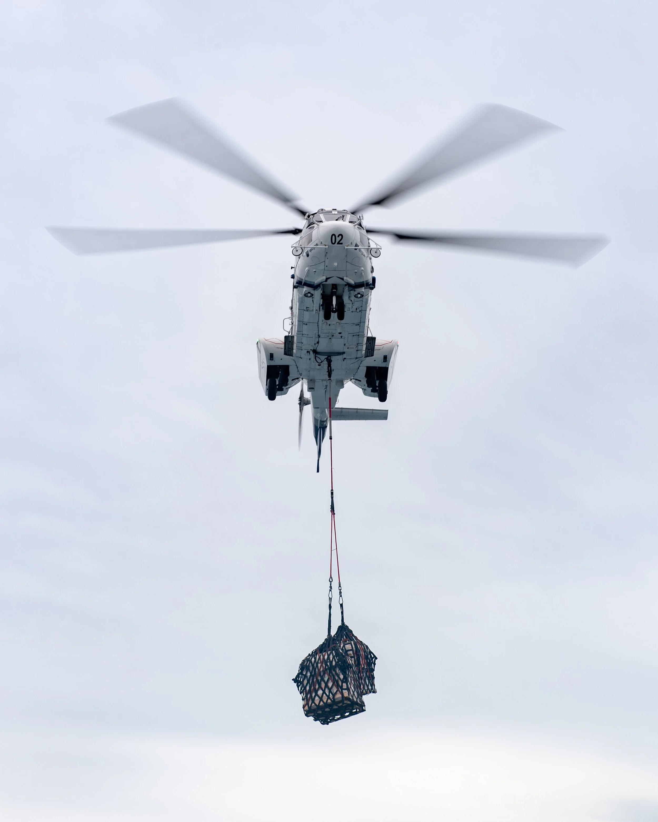  INDIAN OCEAN (Jan. 13, 2022) An Airbus Helicopter H215 assigned to Henry J. Kaiser-class underway replenishment oiler USNS John Ericcson (T-AO 194) approaches t Arleigh Burke-class guided-missile destroyer USS O’Kane (DDG 77) to deliver cargo during
