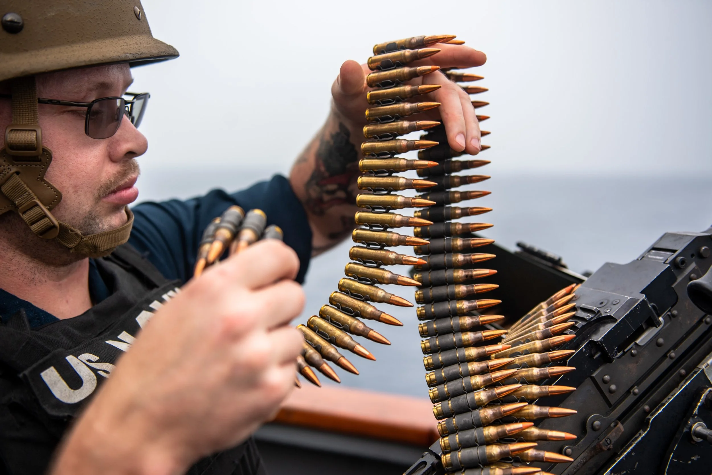  ARABIAN SEA (Sept. 10, 2021) Culinary Specialist 2nd Class Joshua Hatch loads an M240 machine gun while standing watch aboard guided-missile destroyer USS O’Kane (DDG 77) in the Arabian Sea, Sept. 10.  (U.S. Navy photo by Mass Communication Speciali