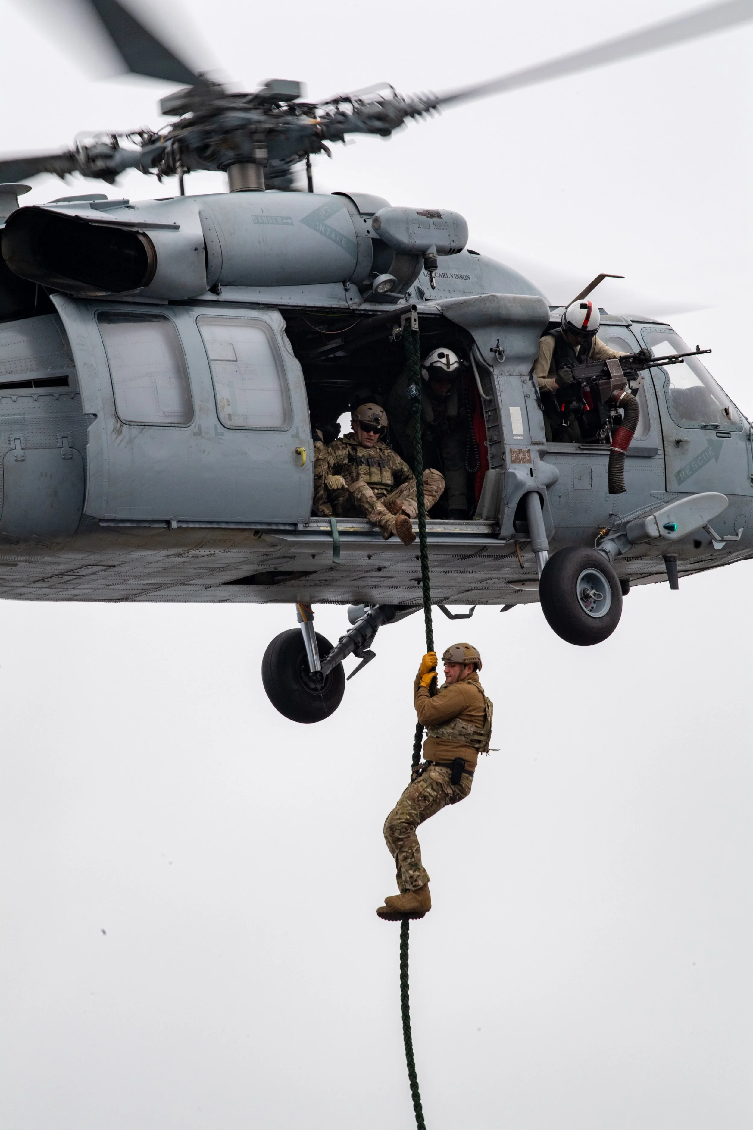  PACIFIC OCEAN (July 4, 2021) Sailors assigned to Explosive Ordnance Disposal Mobile Unit 3 perform a fast rope demonstration for the crew aboard Nimitz-class aircraft carrier USS Carl Vinson (CVN 70), to celebrate Fourth of July, July 4, 2021. (U.S.