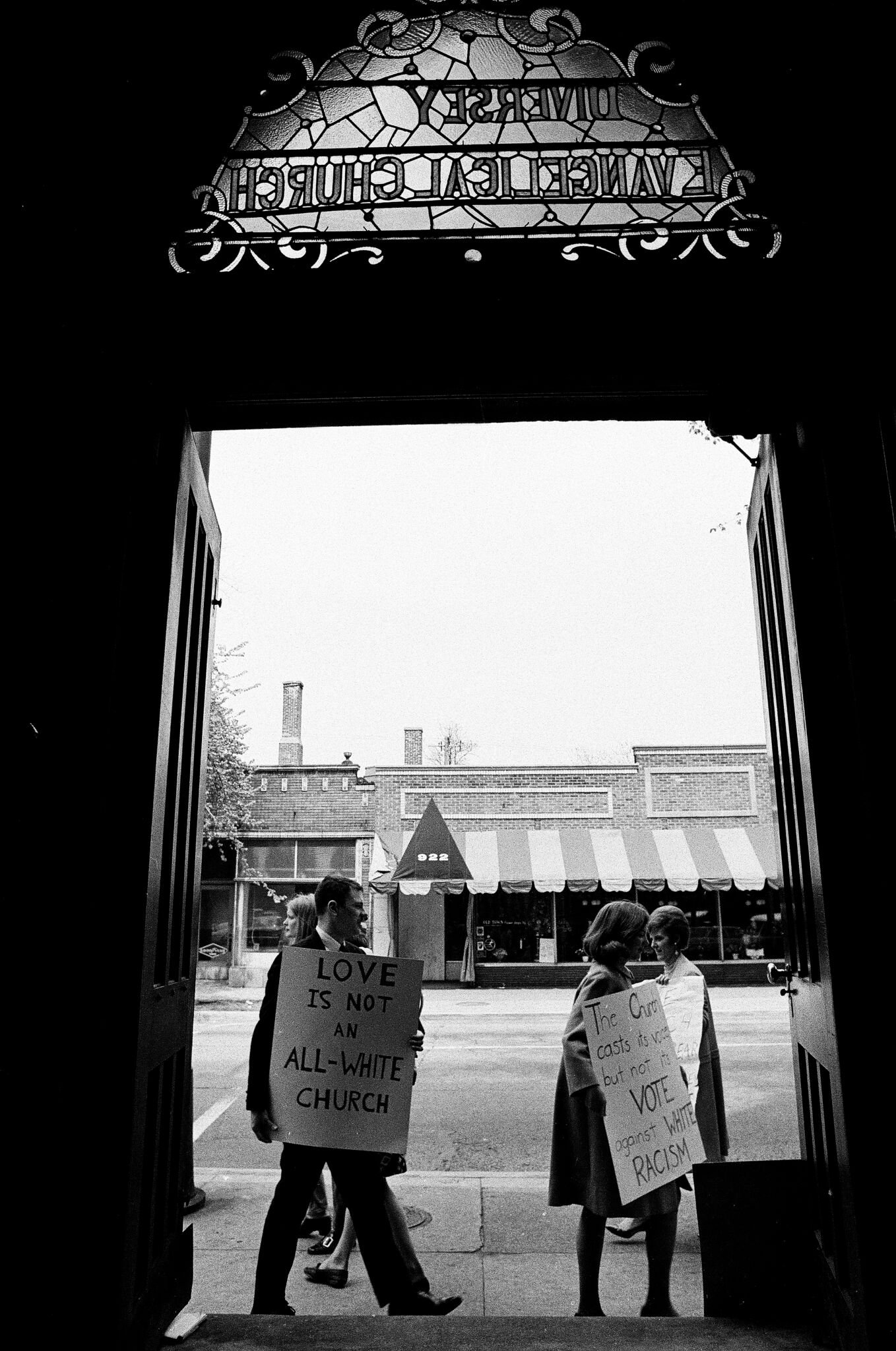 April 28, 1968. Caption from the Chicago History Museum: Picketers encouraging church members to fight against racial discrimination as seen through the door of Holy Covenant United Methodist church. Picketers are also testing an ordinance prohibitin