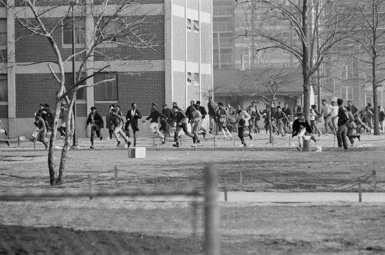 On the one-year anniversary of Dr. Martin Luther King Jr.'s assassination, demonstrations were held across the city of Chicago. In Cabrini, youth are seen running. April 4 1969, ST-12006260-0028, Chicago Sun-Times collection, Chicago History Museum