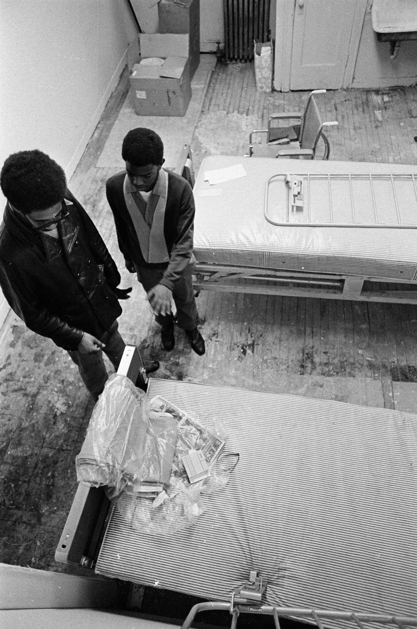 Ralph Bostick shows Bobby Rush donated hospital beds and a wheelchair on December 25, 1969, at the Dedication. Photographer Larry Graff, ST-19030952-0022, Chicago Sun-Times collection, Chicago History Museum