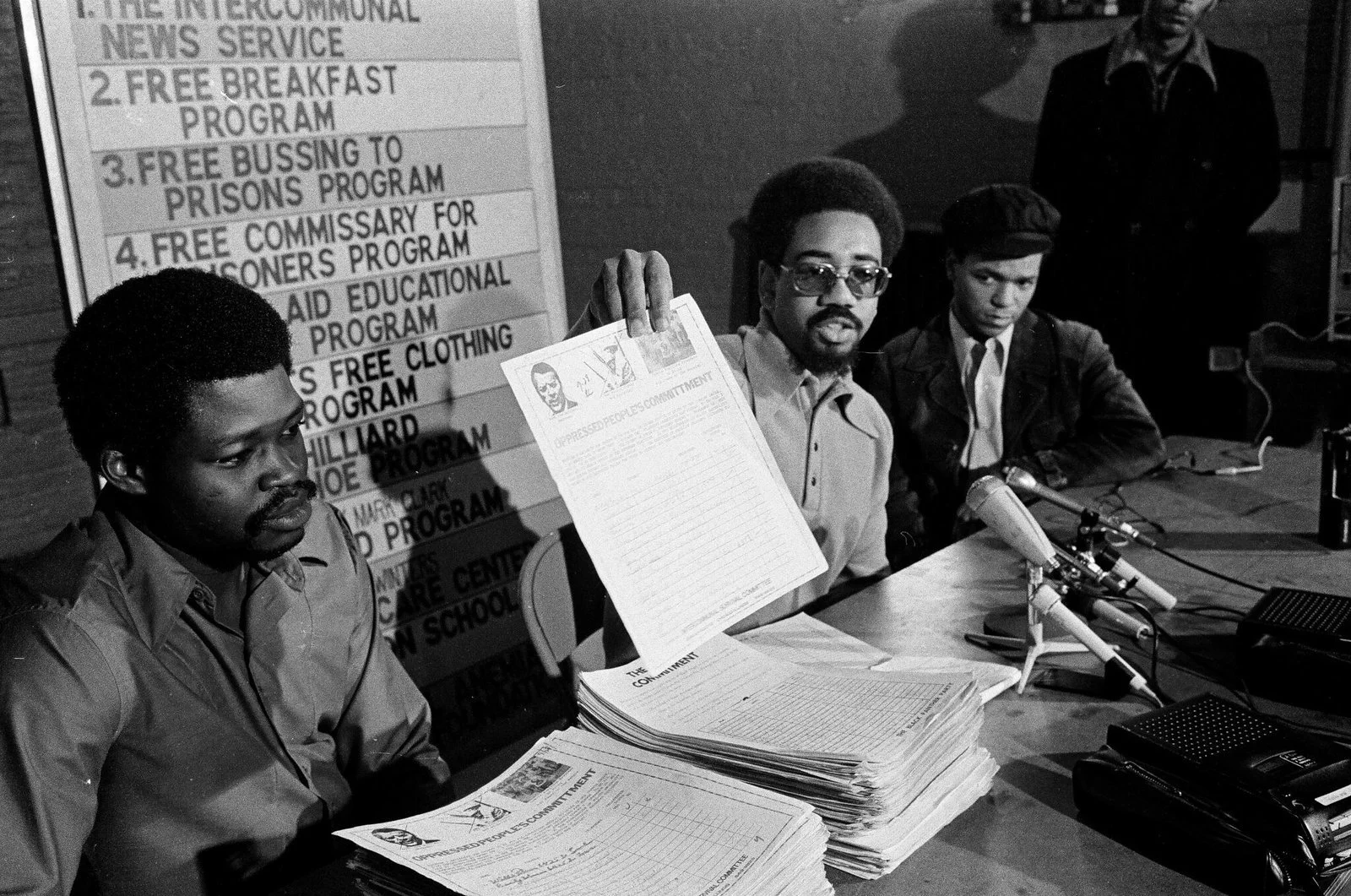 Two stacks of petitions to unseat Hanrahan. (l-r) Harold Bell, Bobby Rush, Ronald "Doc" Satchel at 4233 S. Indiana, Photographer Fred Stein, ST-19030964-0014, Chicago Sun-Times collection, Chicago History Museum