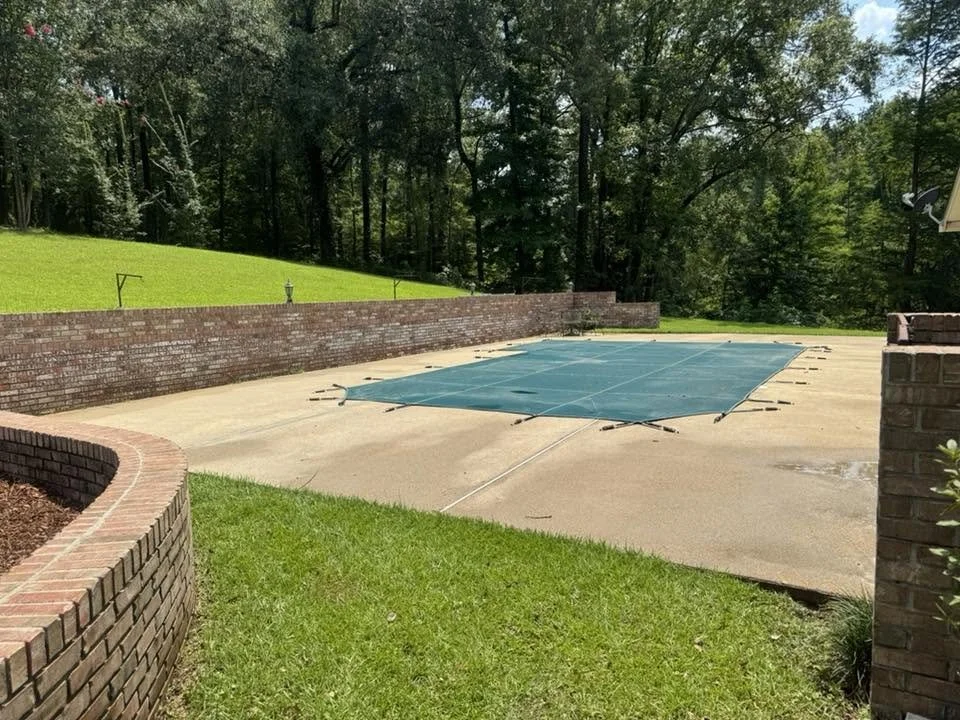 Concrete pool deck cleaning result in Natchez, Mississippi.
