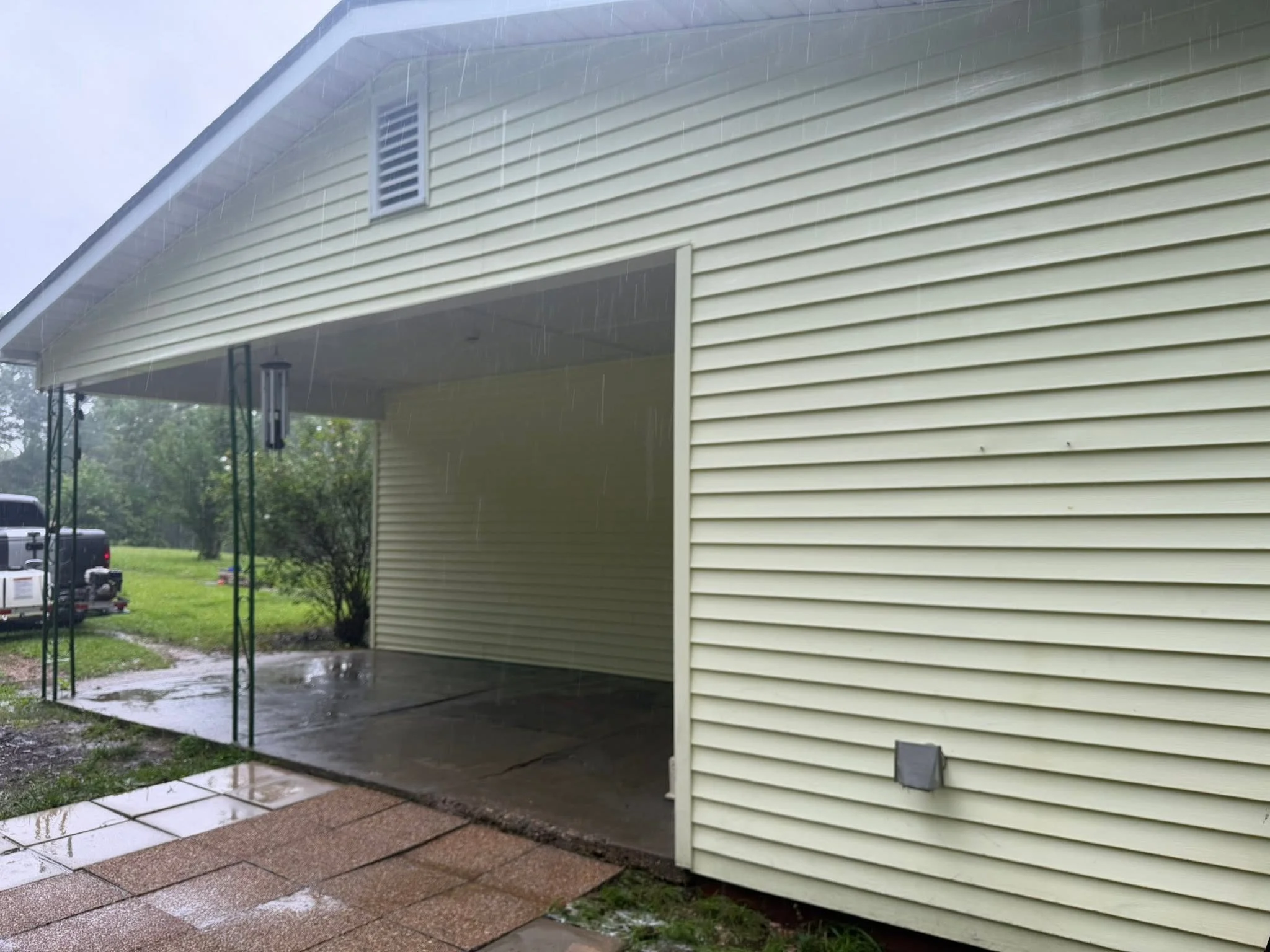 Vinyl siding and covered patio area after exterior cleaning.