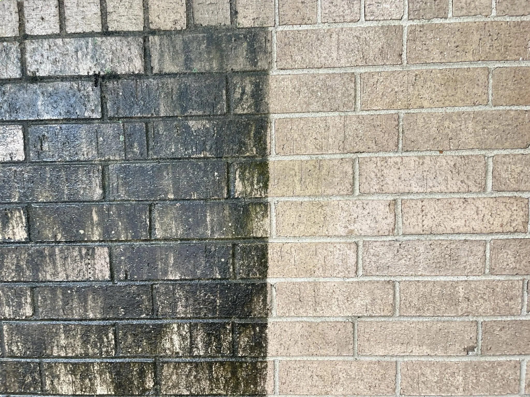 Side by side comparison of a dirty brick wall being cleaned in Natchez, MS.