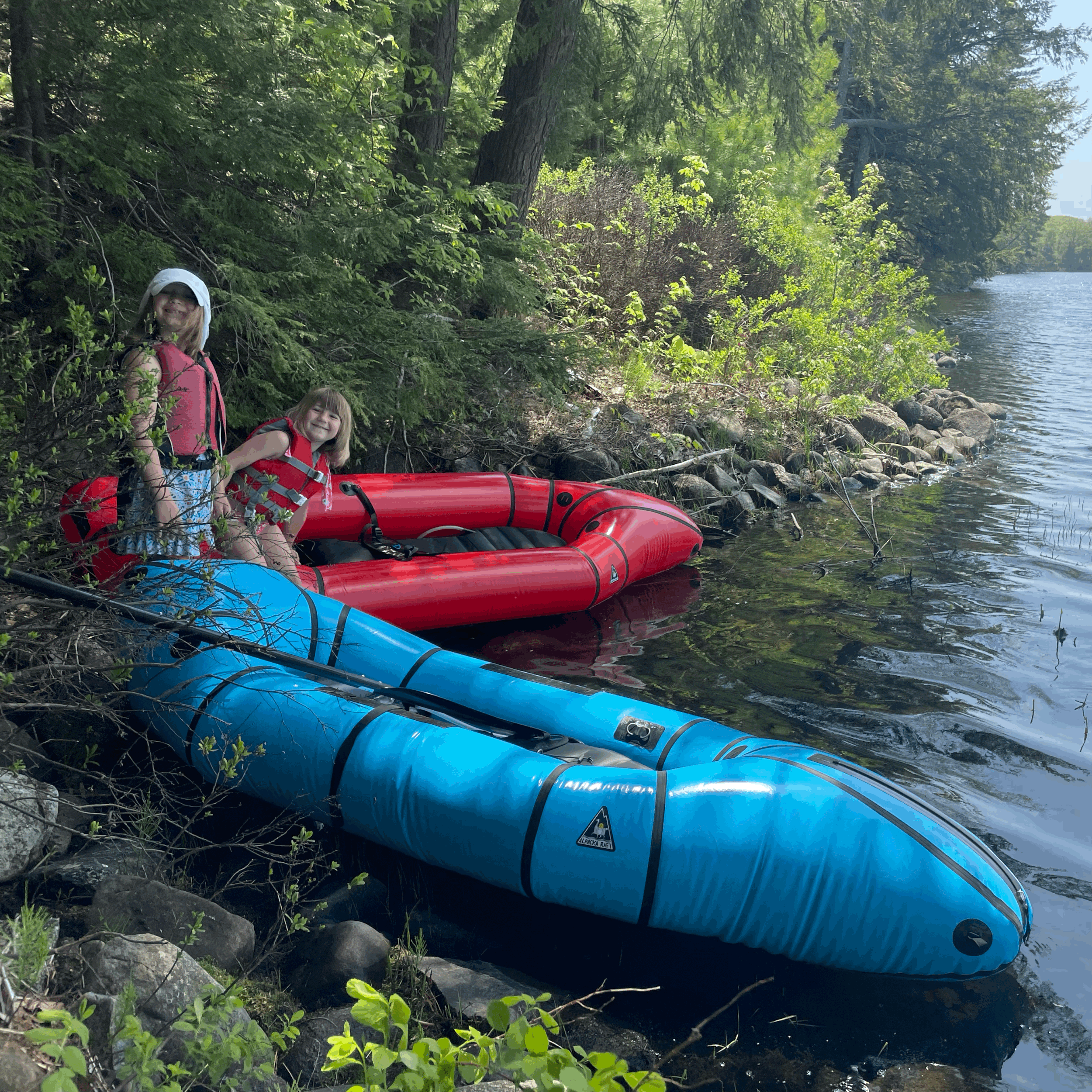 Children stand with packraft at Fields Pond in Maine.