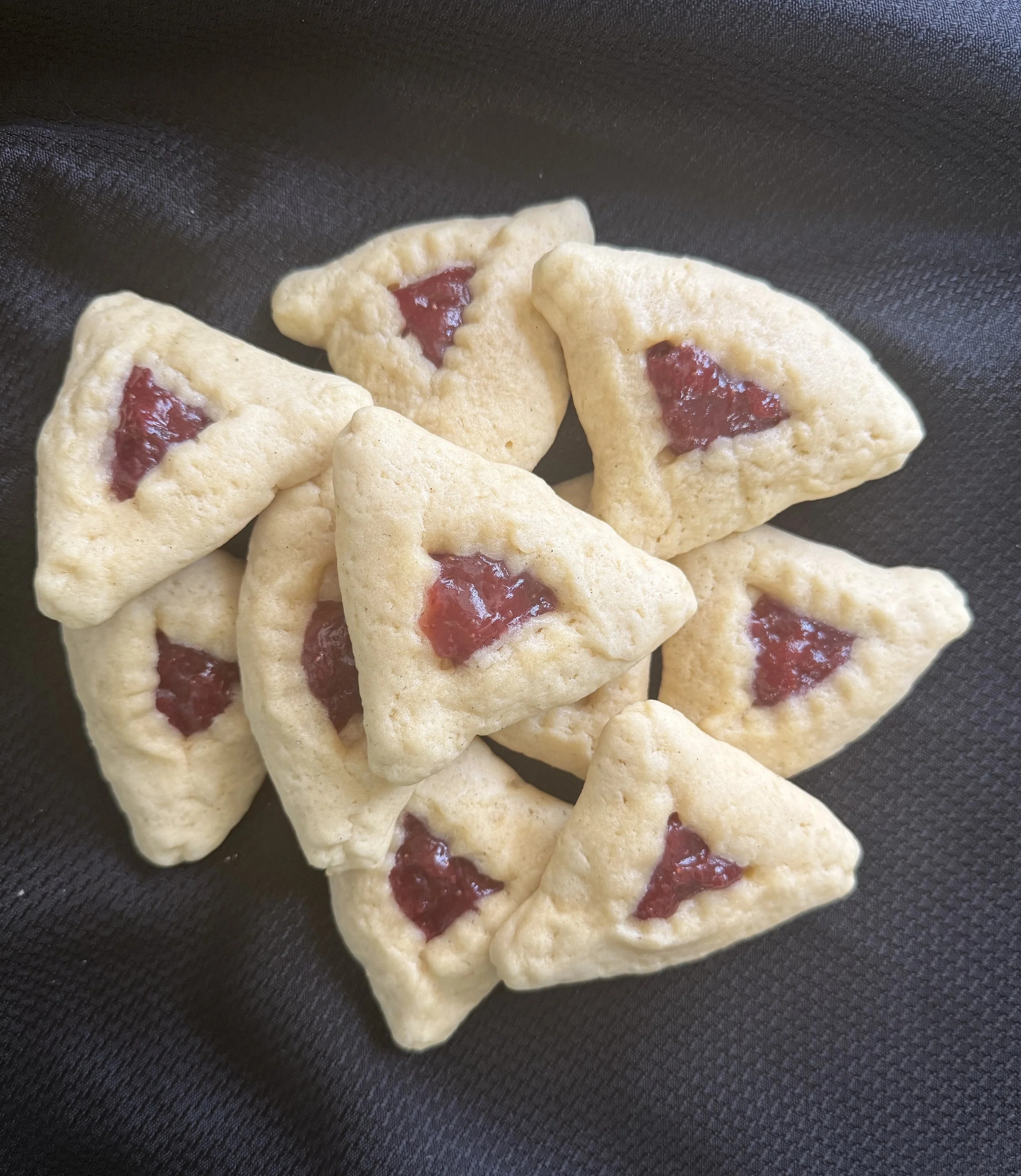 triangular pastries, hamantaschen, filled with strawberries