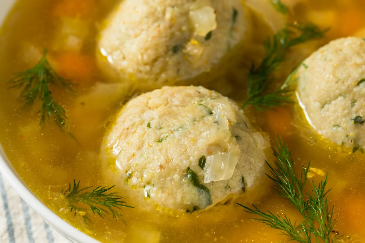 matzo ball soup with dill sprigs