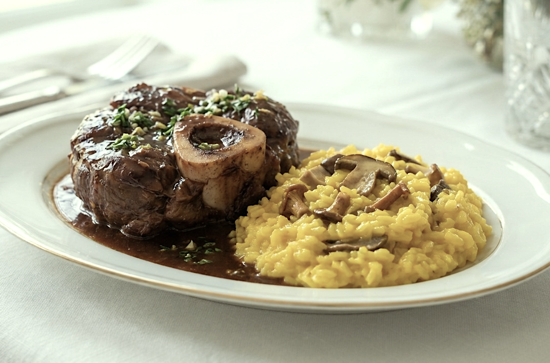 osso bucco on a plate with saffron mushroom risotto