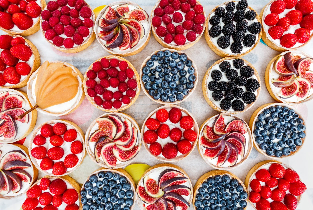 cream tarts topped with a variety of fruits