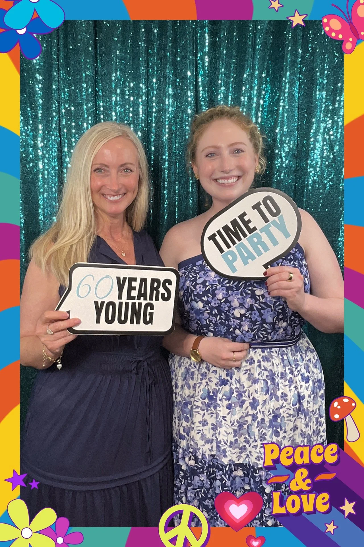 mother and daughter smiling as they get their photo taken in photo booth