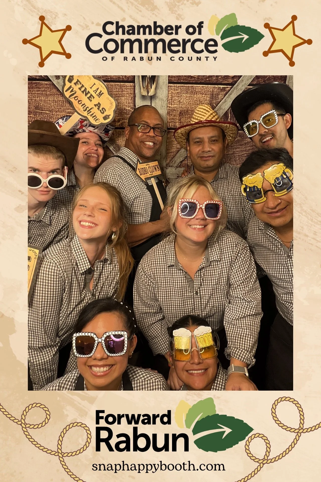 Western-themed photo booth setup with rustic backdrop, cowboy props, and red carpet at the Rabun County Chamber of Commerce event in Clayton, GA.