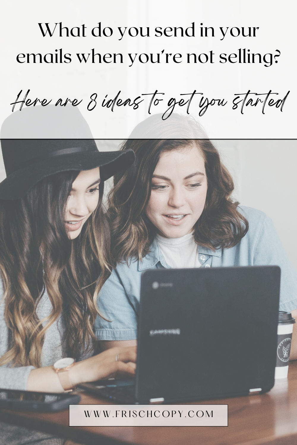 Two women sitting together, seeming happy, looking toward a laptop screen that we cannot see