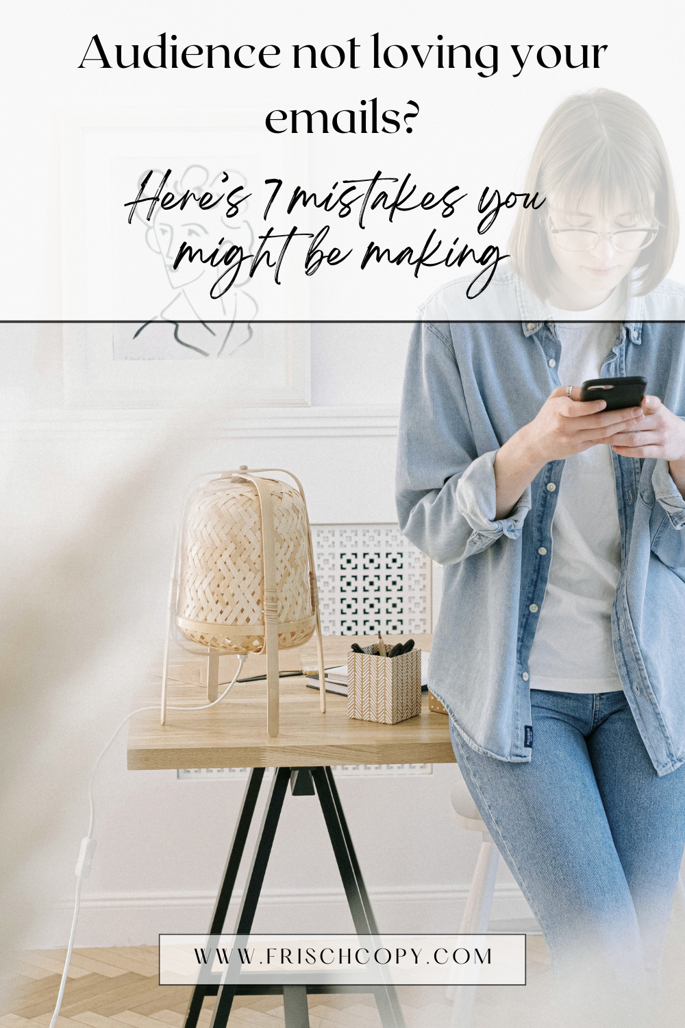 A woman is standing in an office, leaning against a desk. She's holding her phone with both hands as she looks seriously at the screen