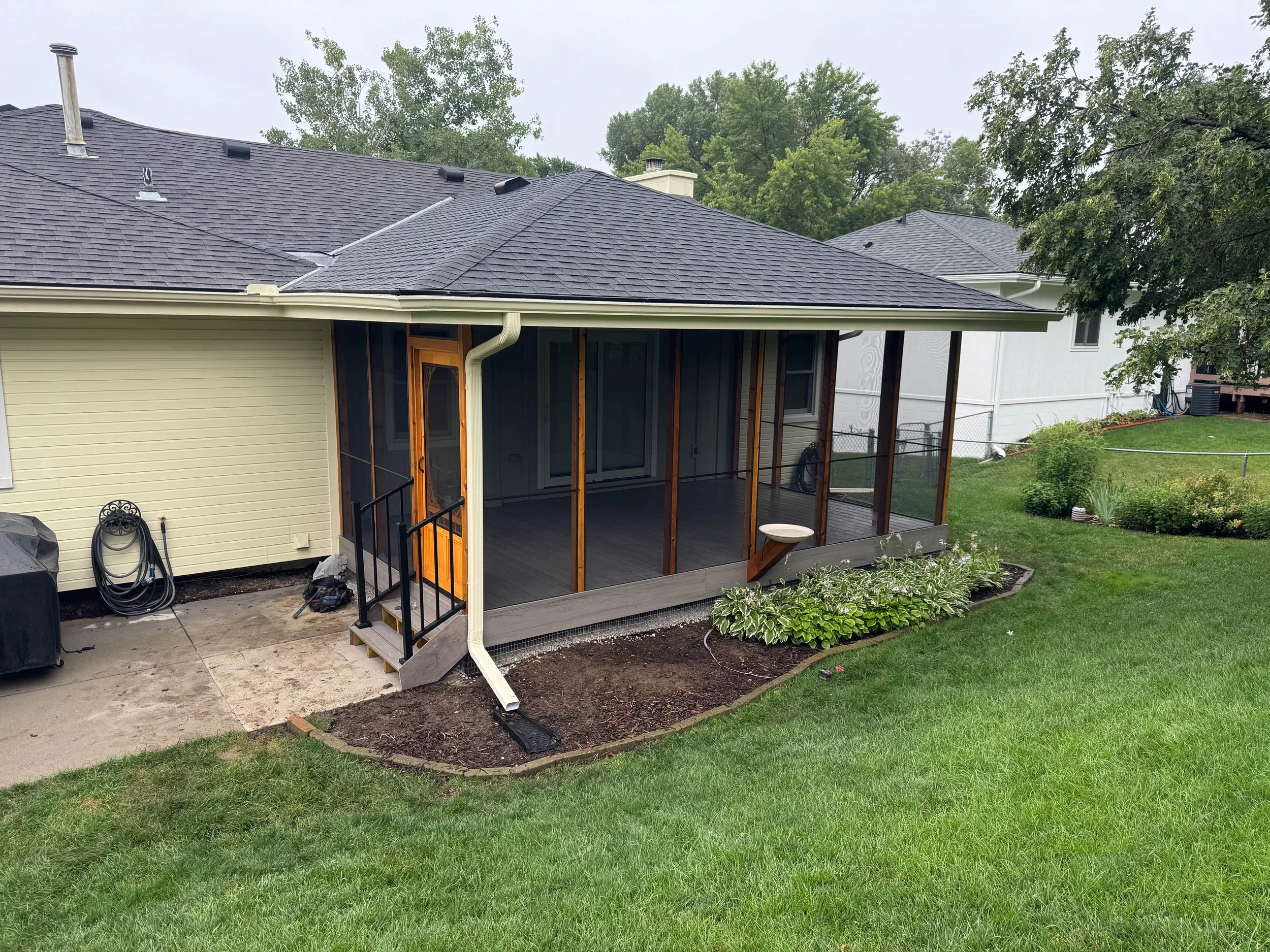 Custom screened-in composite deck with covered roof built in the Omaha metro area