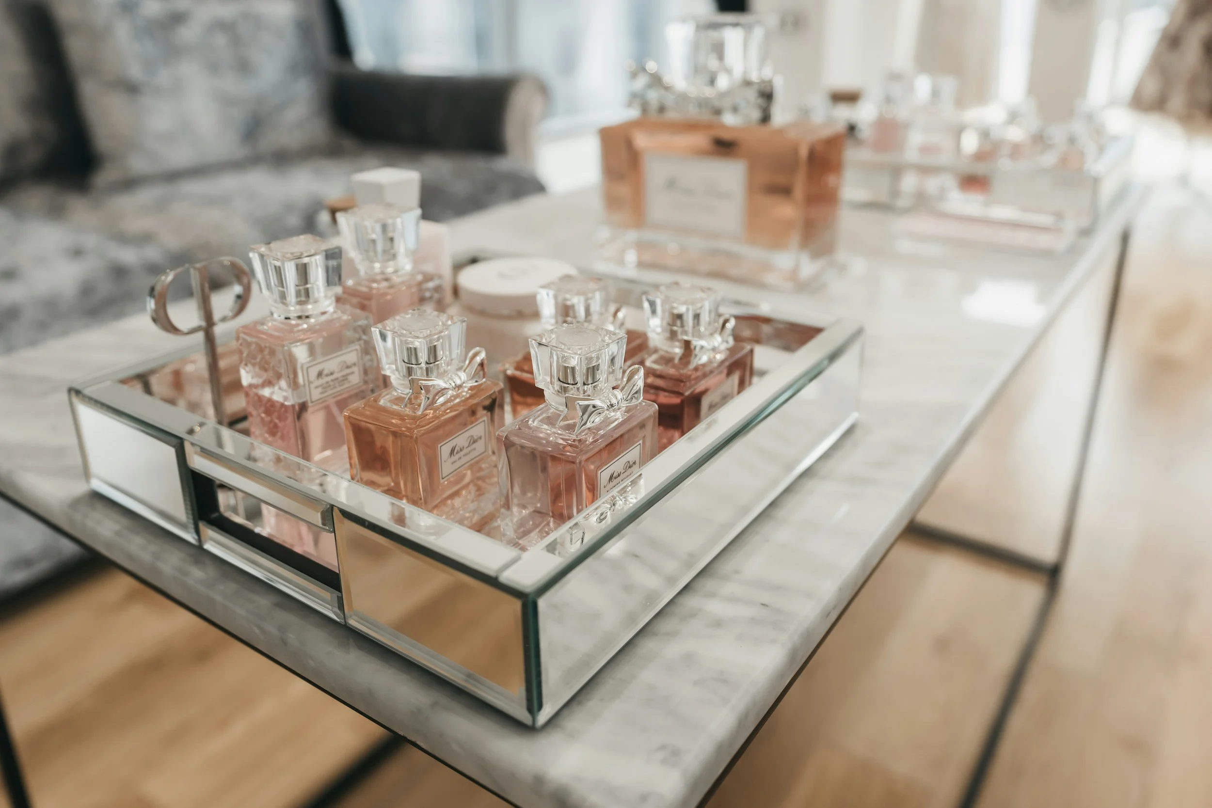 Curated collection of luxury home fragrance products layered across premium home interior