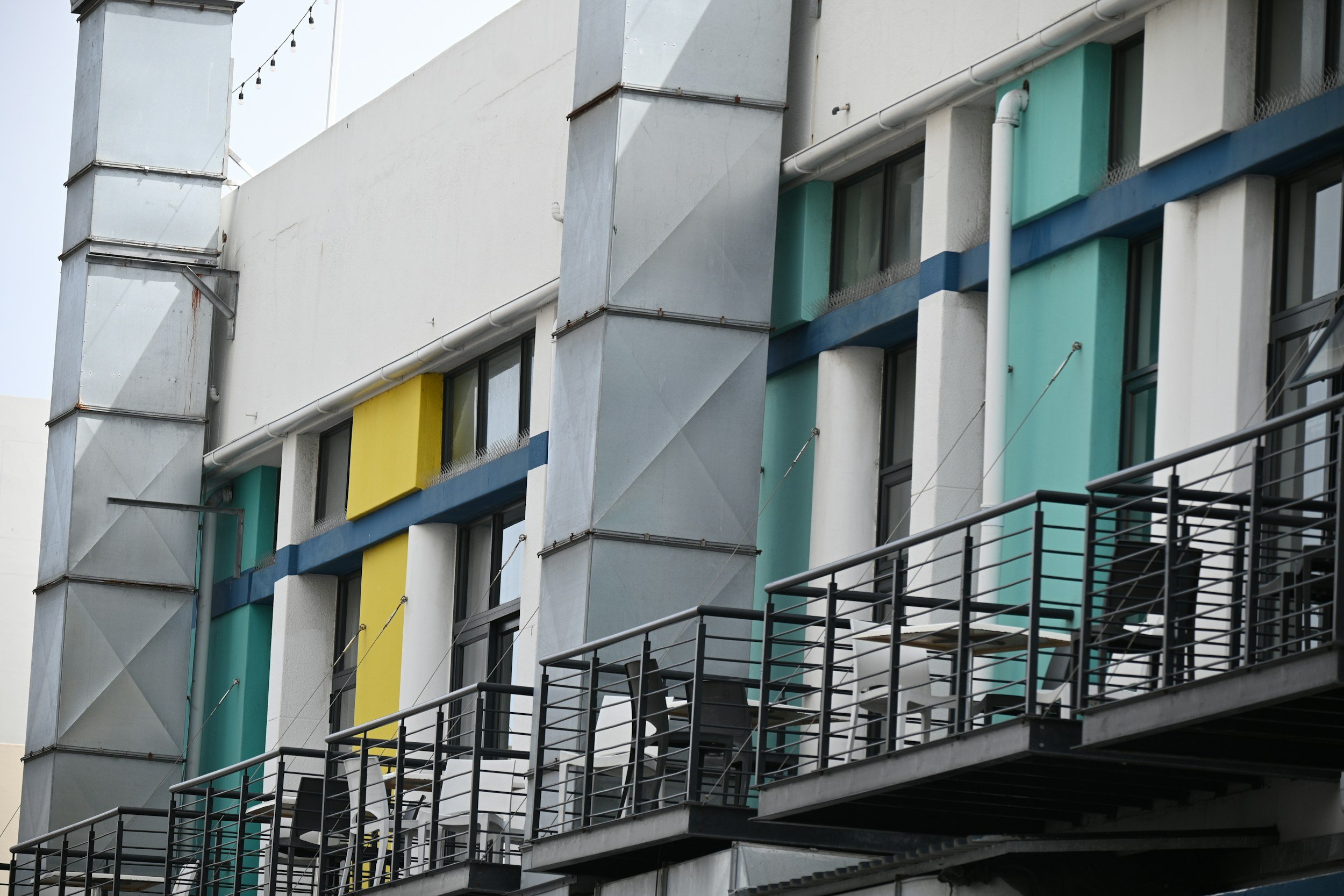 Apartment building balconies where smoke can drift between units