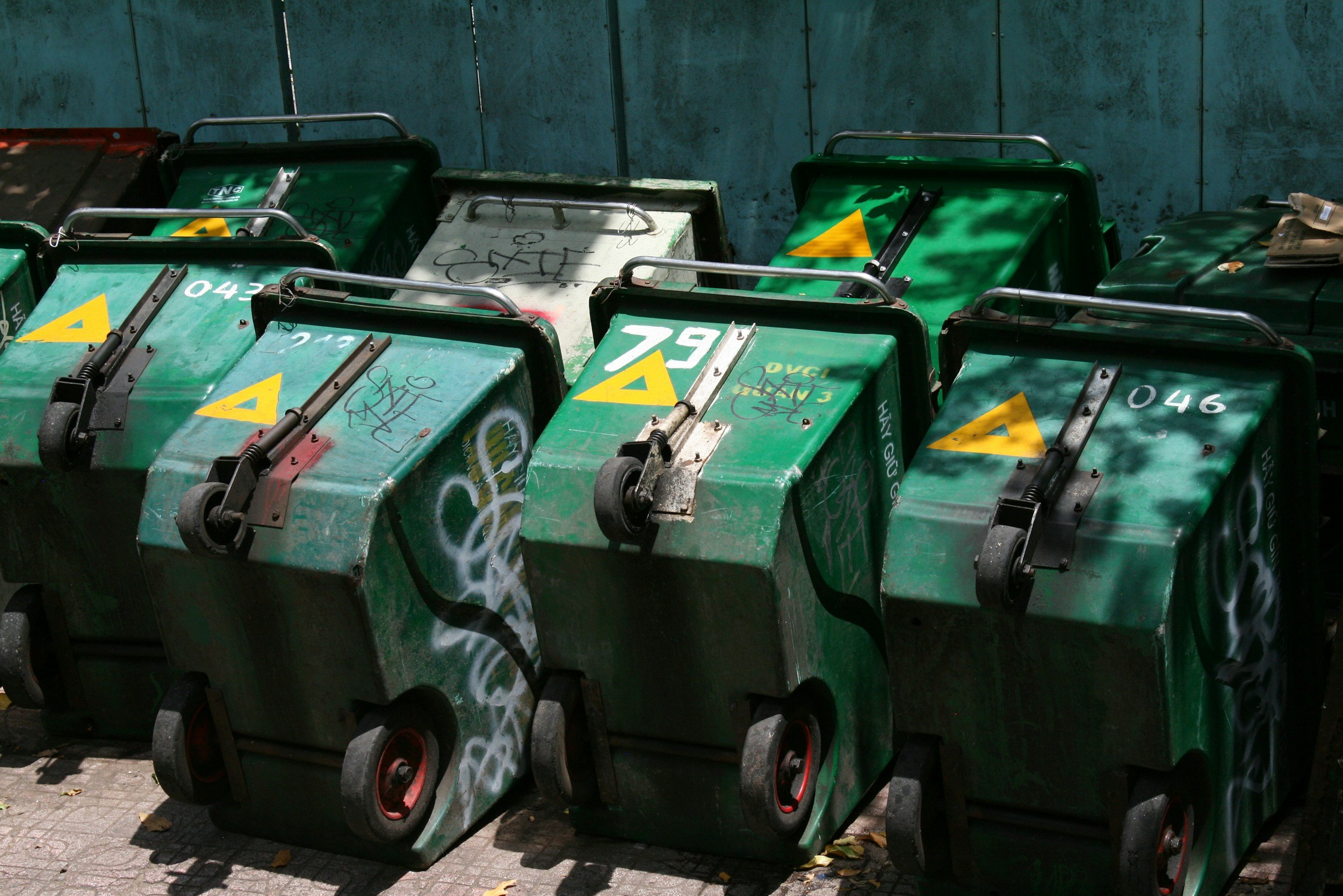 Row of wheelie bins in a building waste area