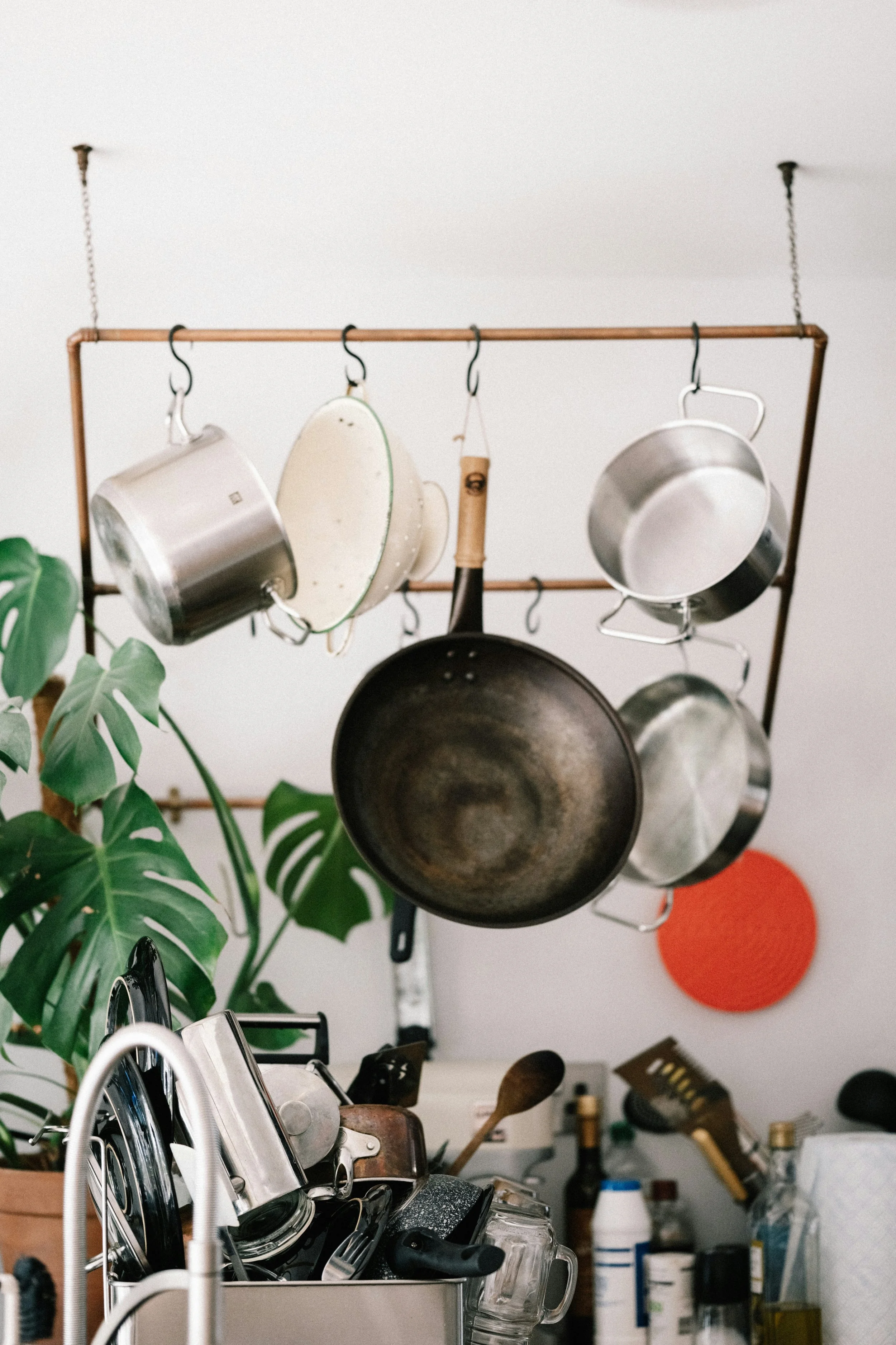 Pots and pans hanging on a rack over a sink