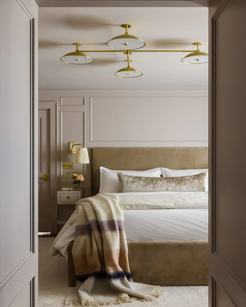 A custom bed and nightstands, soaked in a sultry neutral, transformed this compact primary bedroom into a well
-appointed suite, reminiscent of the homeowners&rsquo; favorite hotel escapes. Design: @kobelandco Photography: @natesheetsphoto