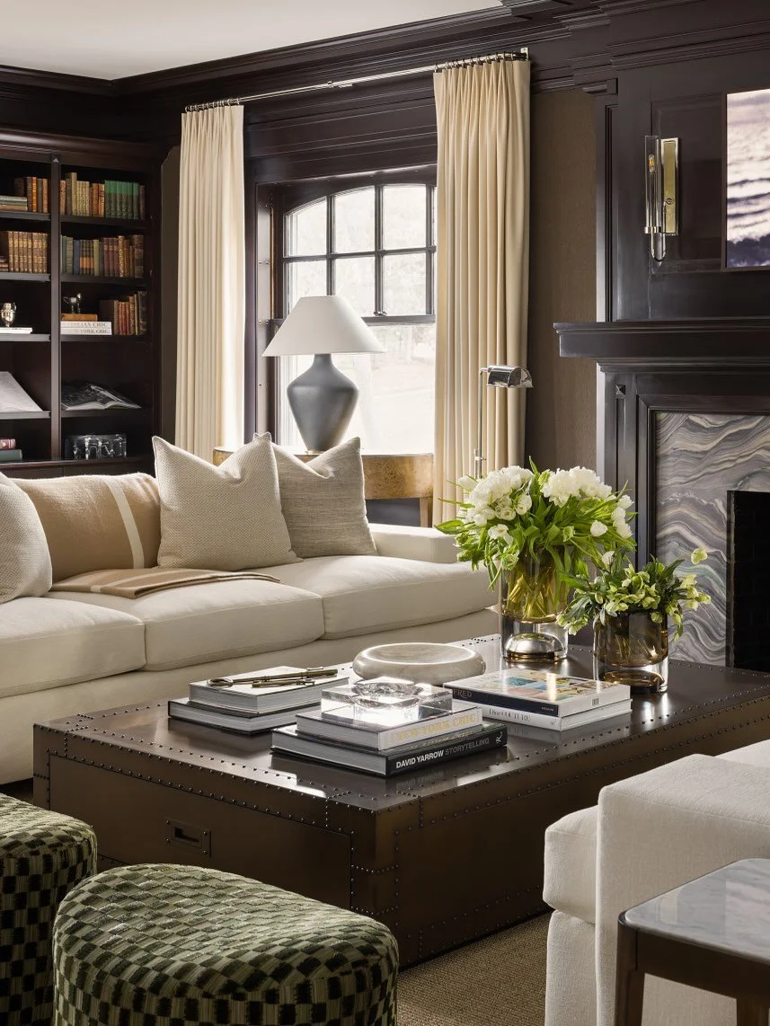 The addition of a curved bar for old-school entertaining and ample seating in soft whites and leather hues, make the formal living room of this historic home the perfect space for holiday hosting or just a nightcap for two. Design: @kobelandco Photog