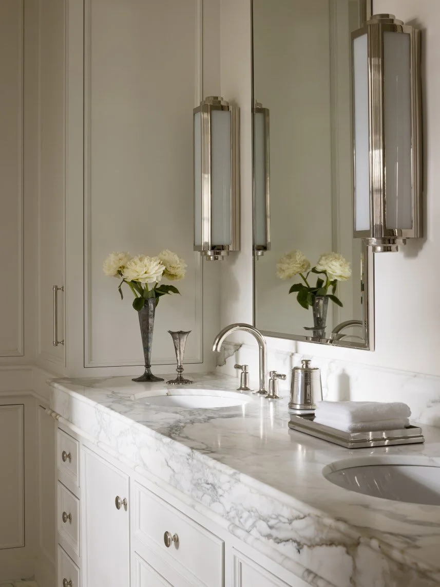 We reimagined the primary bathroom of our Sunset Hill project with details that honor the home&rsquo;s era - custom polished-nickel shower doors, a bespoke tile floor pattern, and classic lighting and fixtures that bring timeless character to the spa