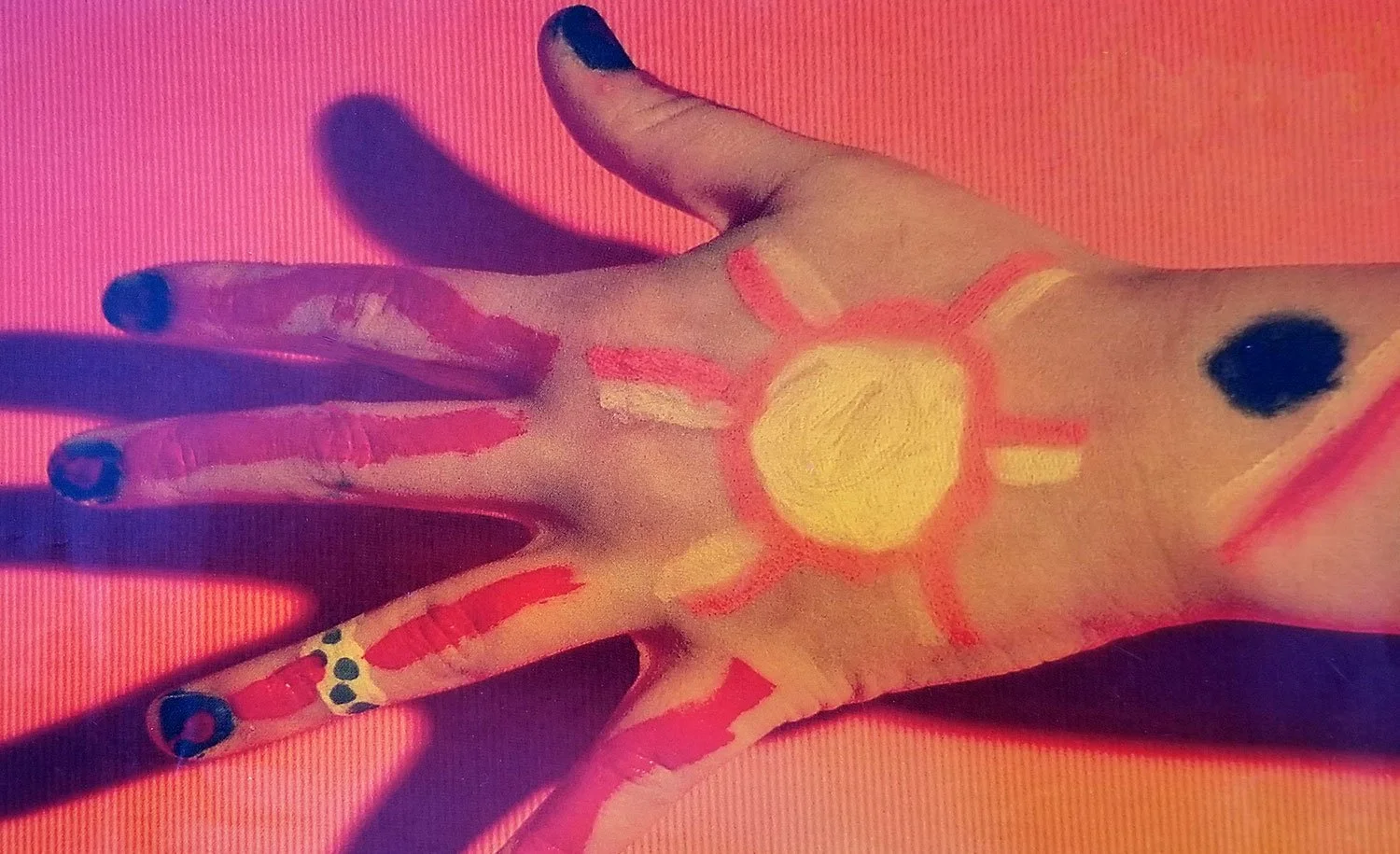 Child's painted hand in art workshop