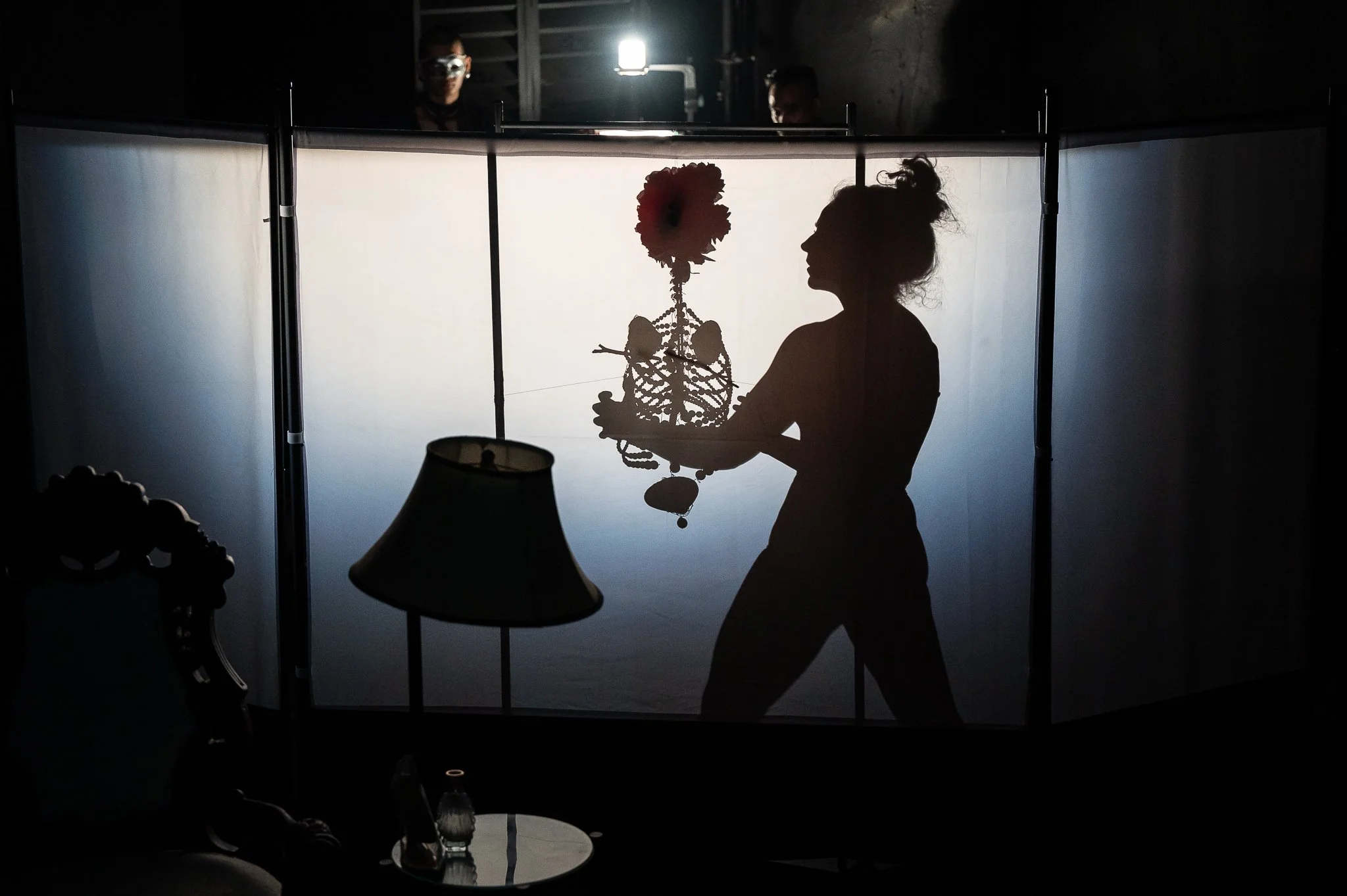 Artist holds flowering ribs prop in front of projector