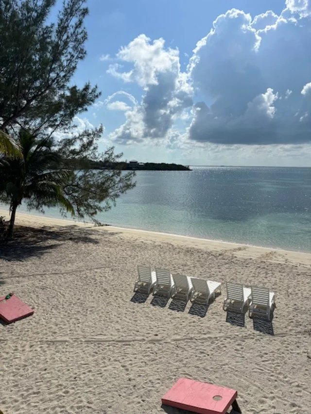 Beach view from the kitchen balcony.  Chairs and cornhole on the beach for hours of relaxation and family fun.