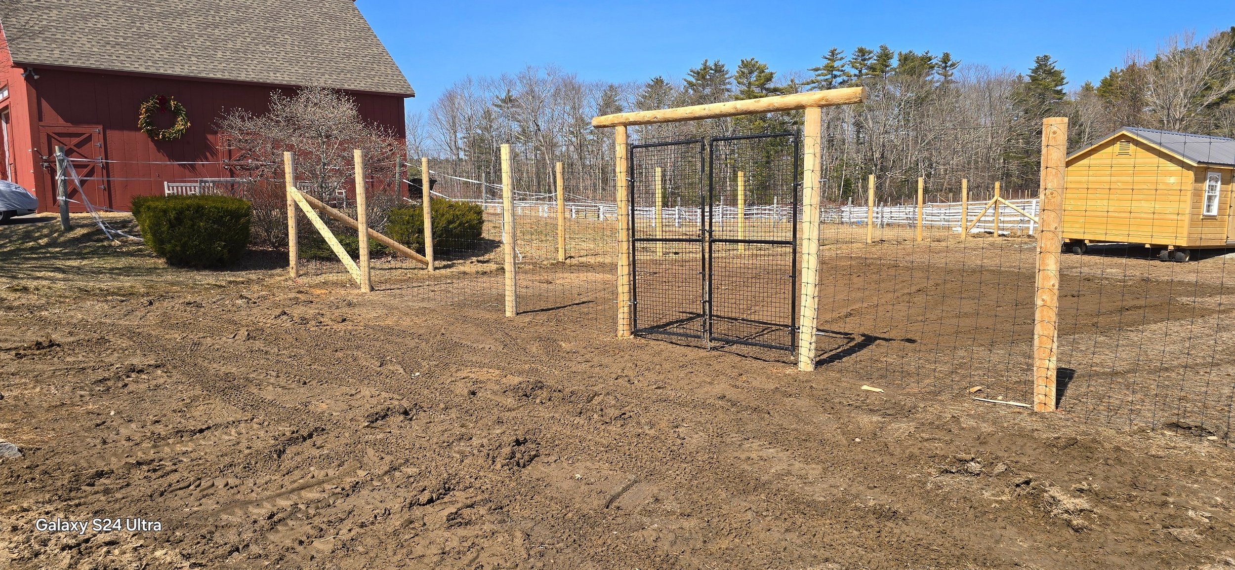 8' tall black steel deer fence on natural cedar posts with custom arbor gate (DF5)