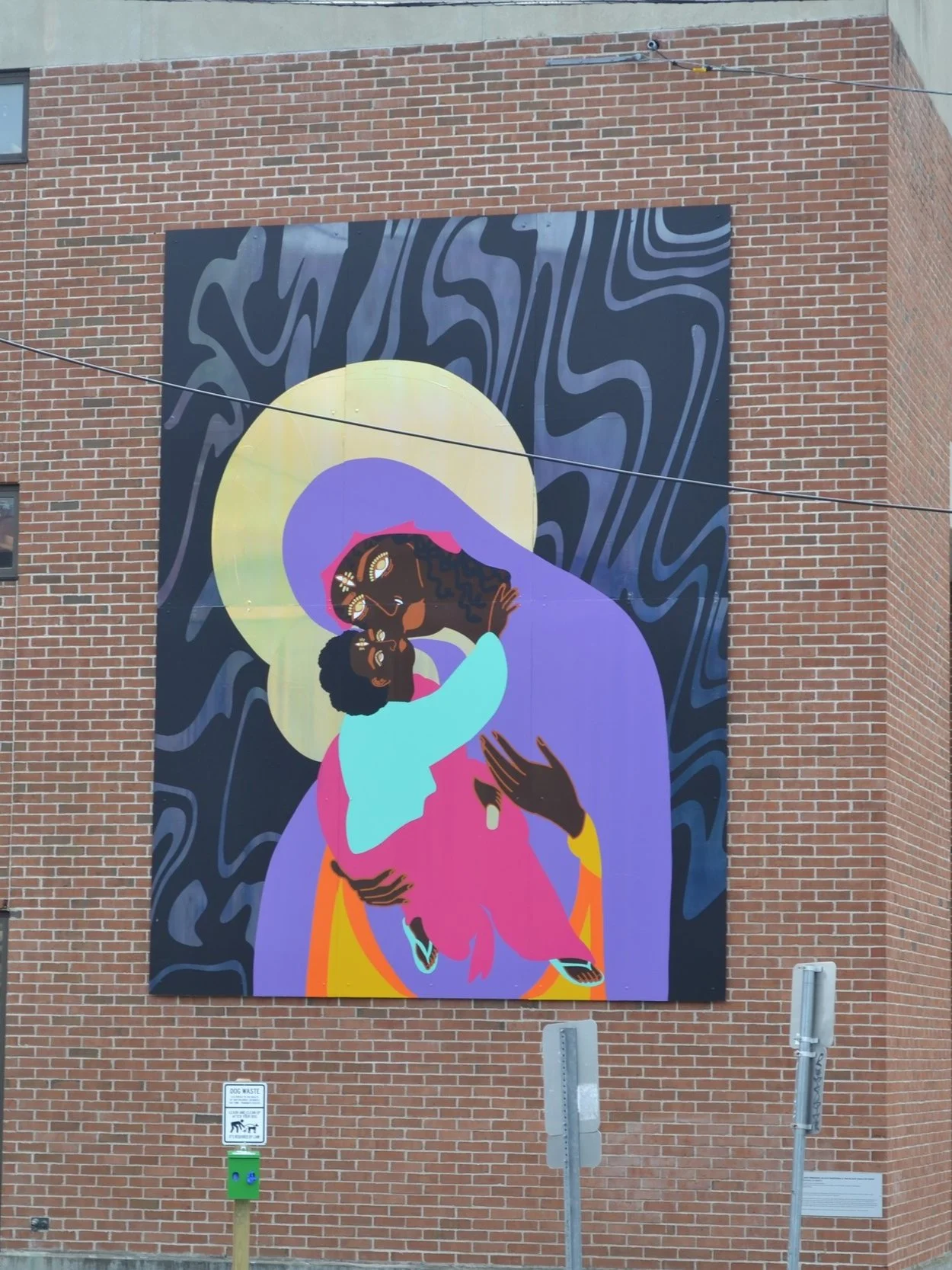 Black Freedom, The Black Madonna & The Black Child of Hope — vinyl mural by Raph Draws depicting a Black Madonna in purple robes holding a child beneath a golden halo, installed at Fletcher Free Library, Burlington VT, Juneteenth 2022