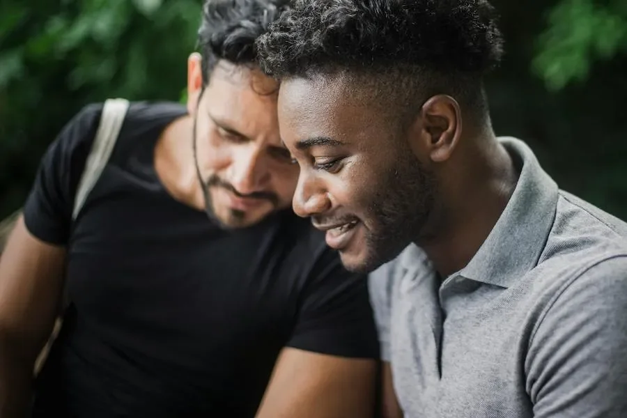 Two guys looking at a phone