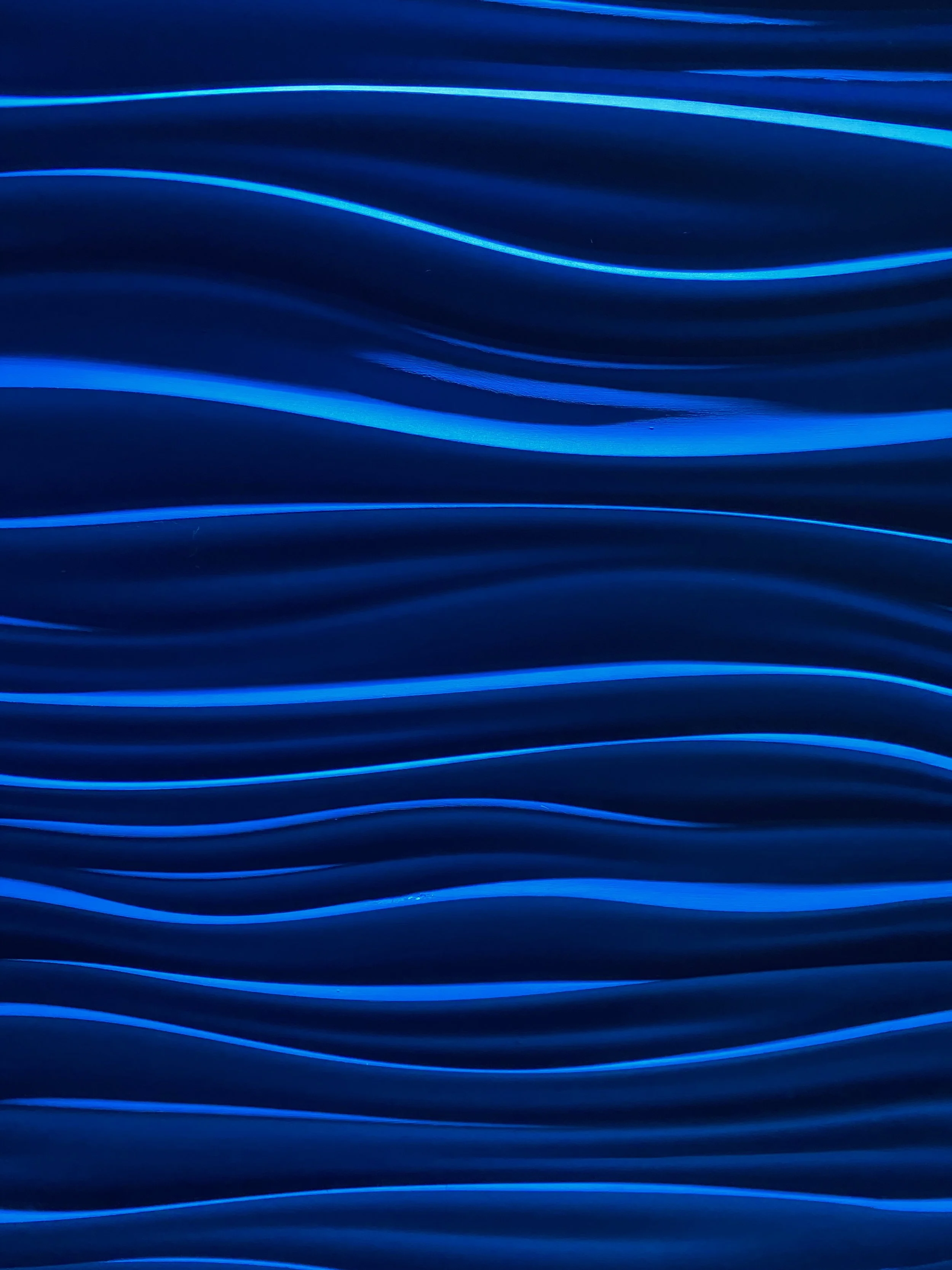 Blue glowing wavy lines on a dark background.