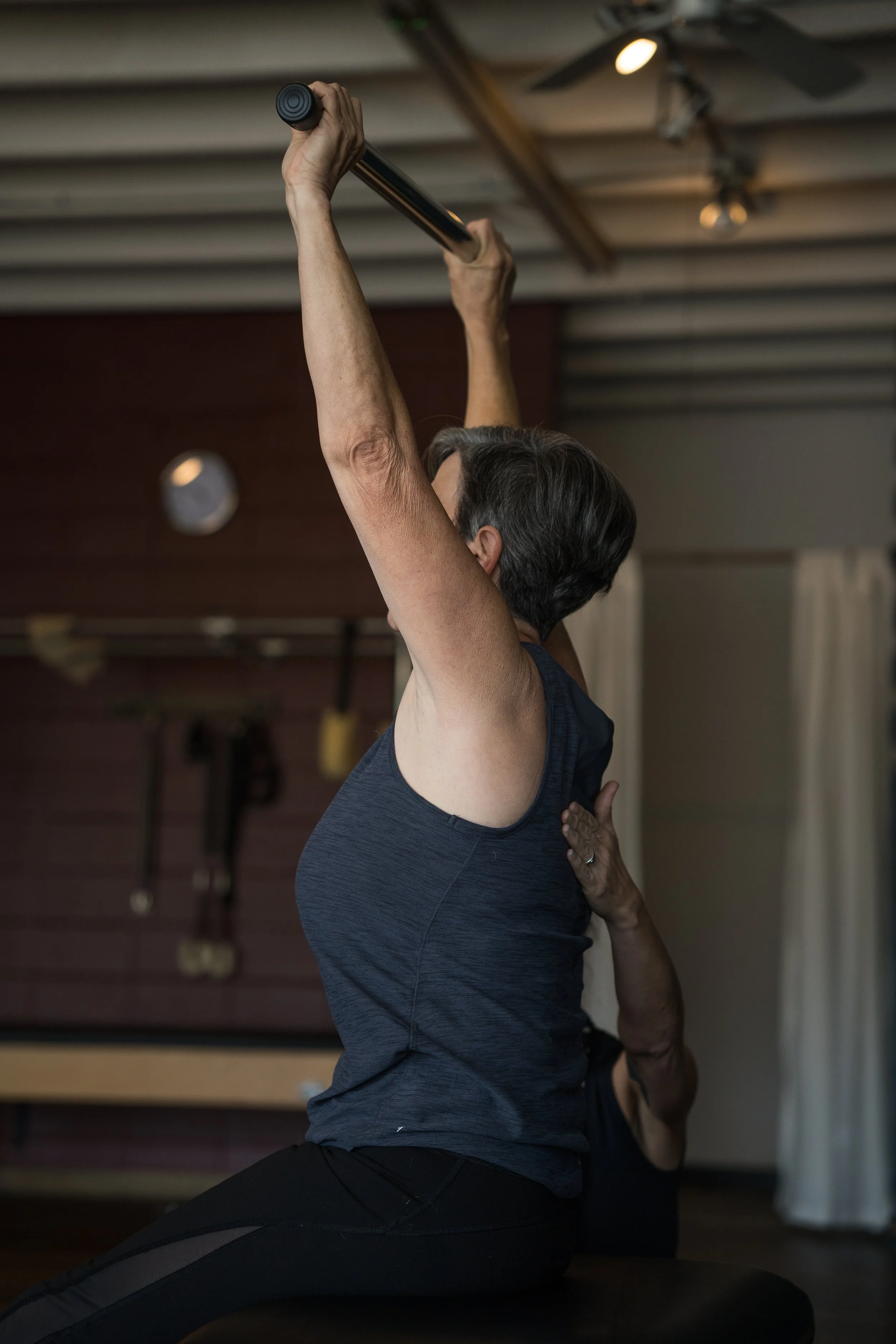 woman on reformer sitting box