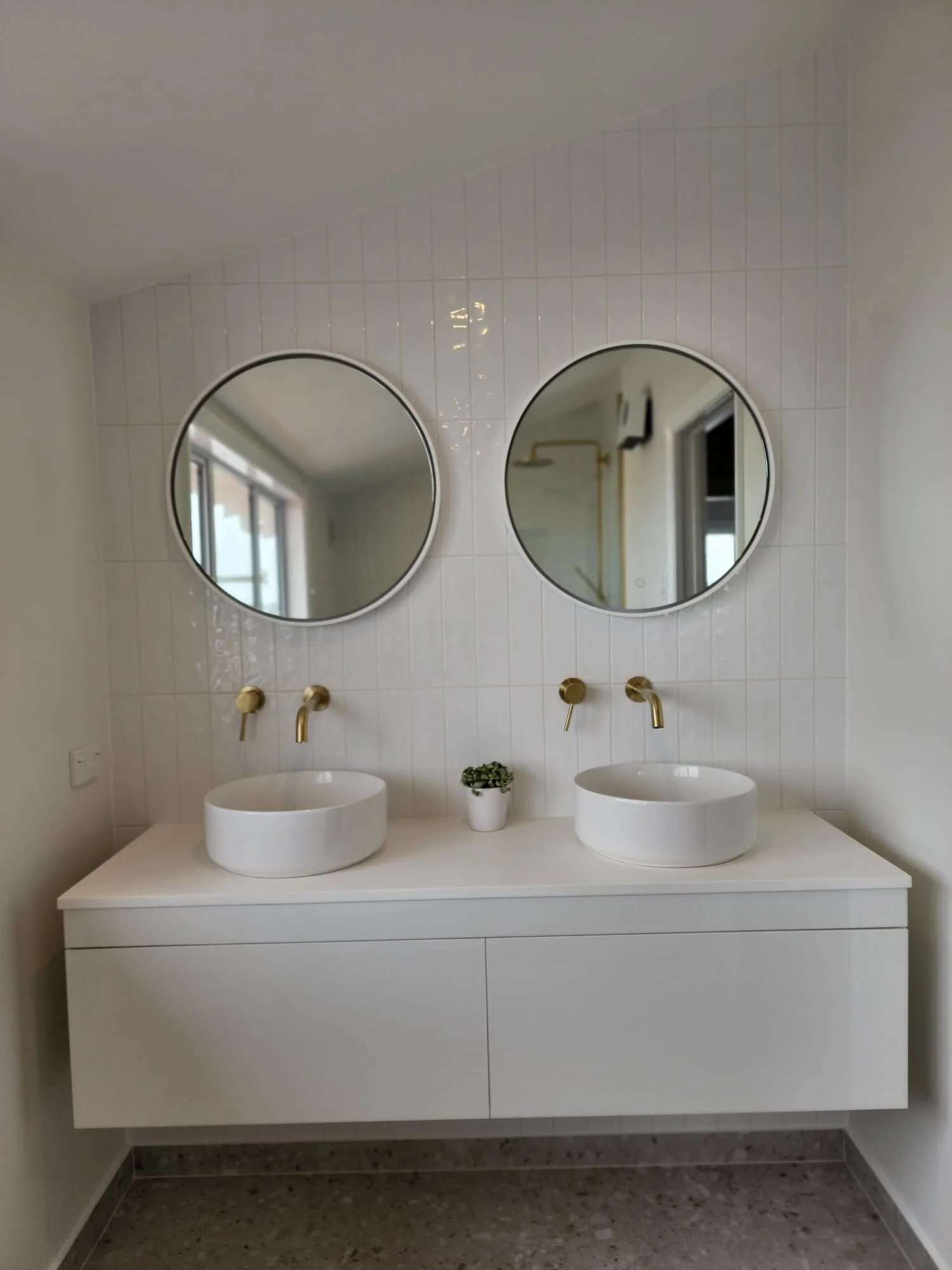 Modern bathroom renovation in Dunedin featuring a tiled walk-in shower and a double-basin wall-hung vanity